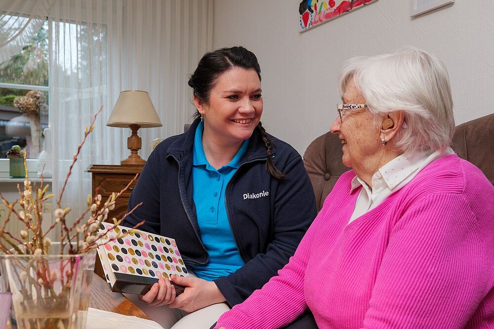 Pflegerin unterhält sich mit Kundin